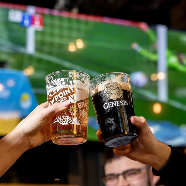 Celebrating a win by cheersing pints